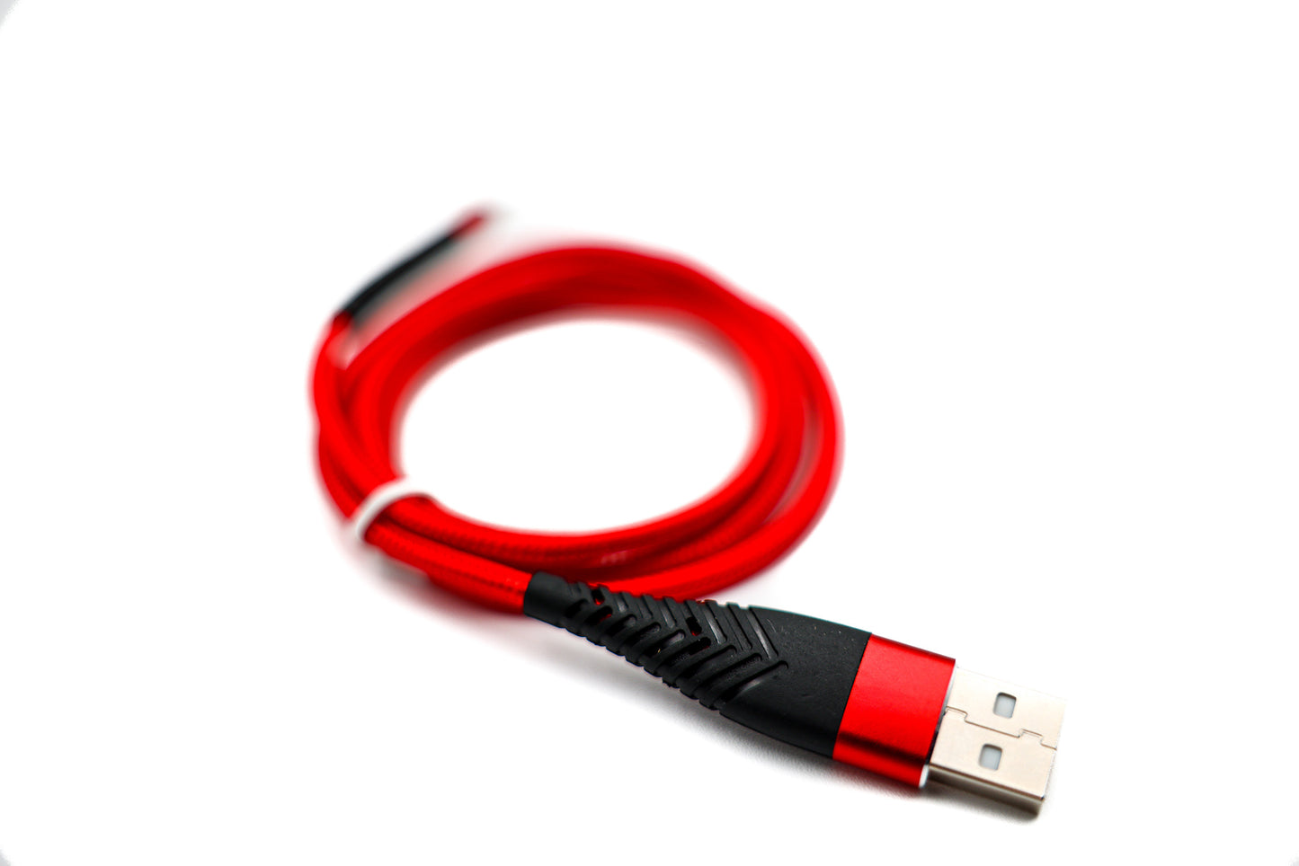 
                  
                    A red USB-C smart chip charger photographed on a brilliant white background
                  
                