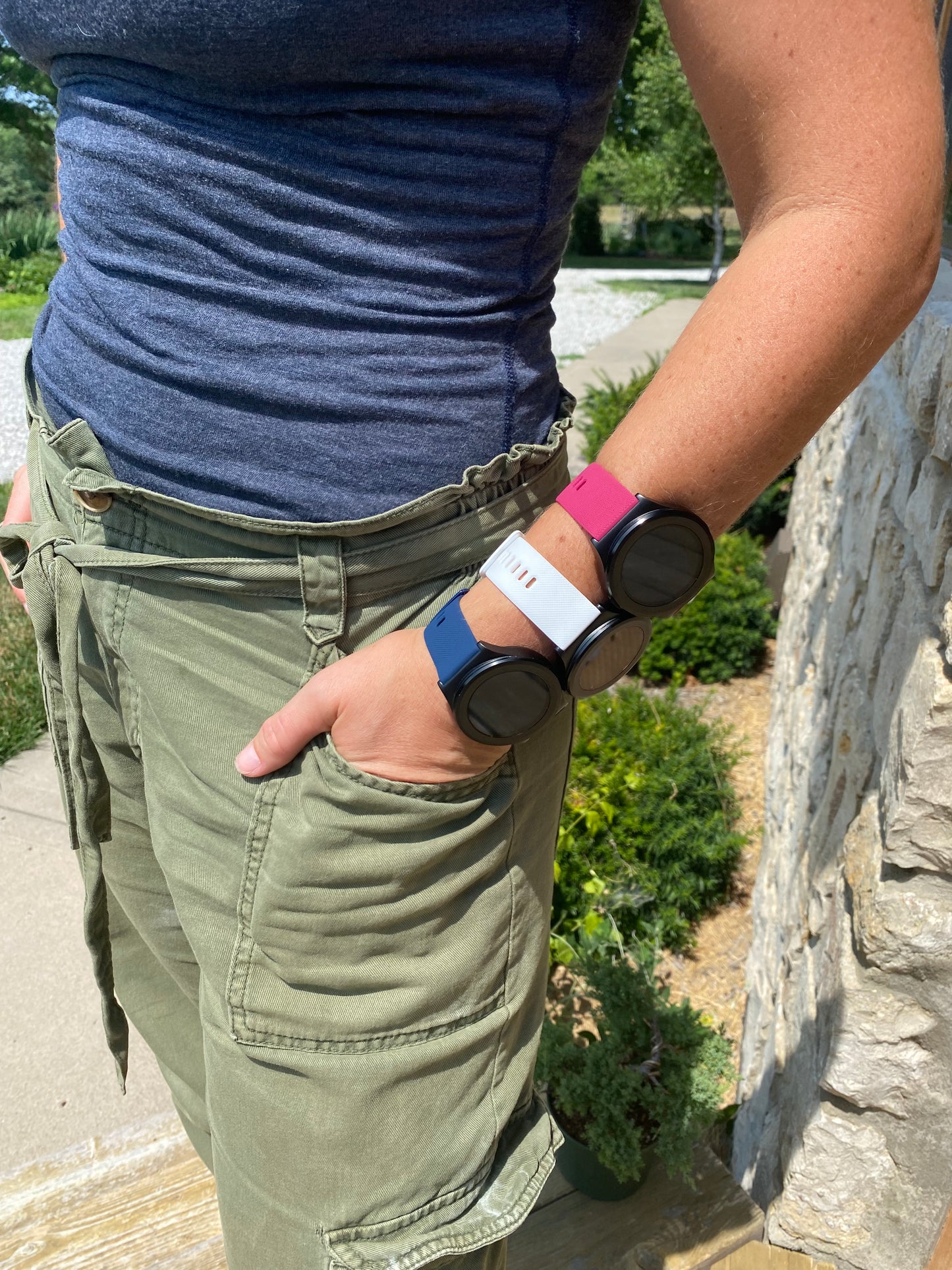 
                  
                    EMF PROTECTION  - Image of a woman standing outside in the sunshine, wearing three W1 Watches on one wrist, with different colored straps
                  
                