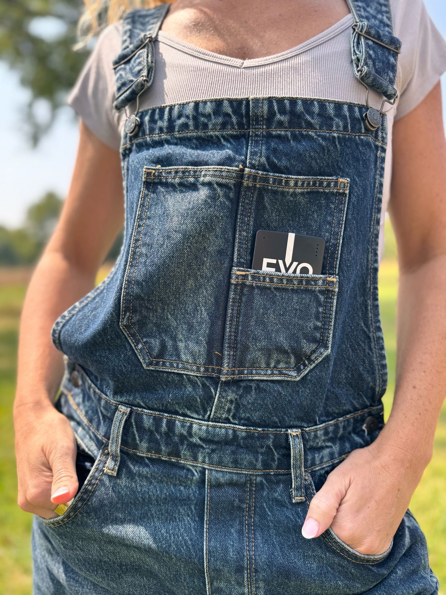
                  
                    The EVO portable sits in the front pocket of their overalls
                  
                