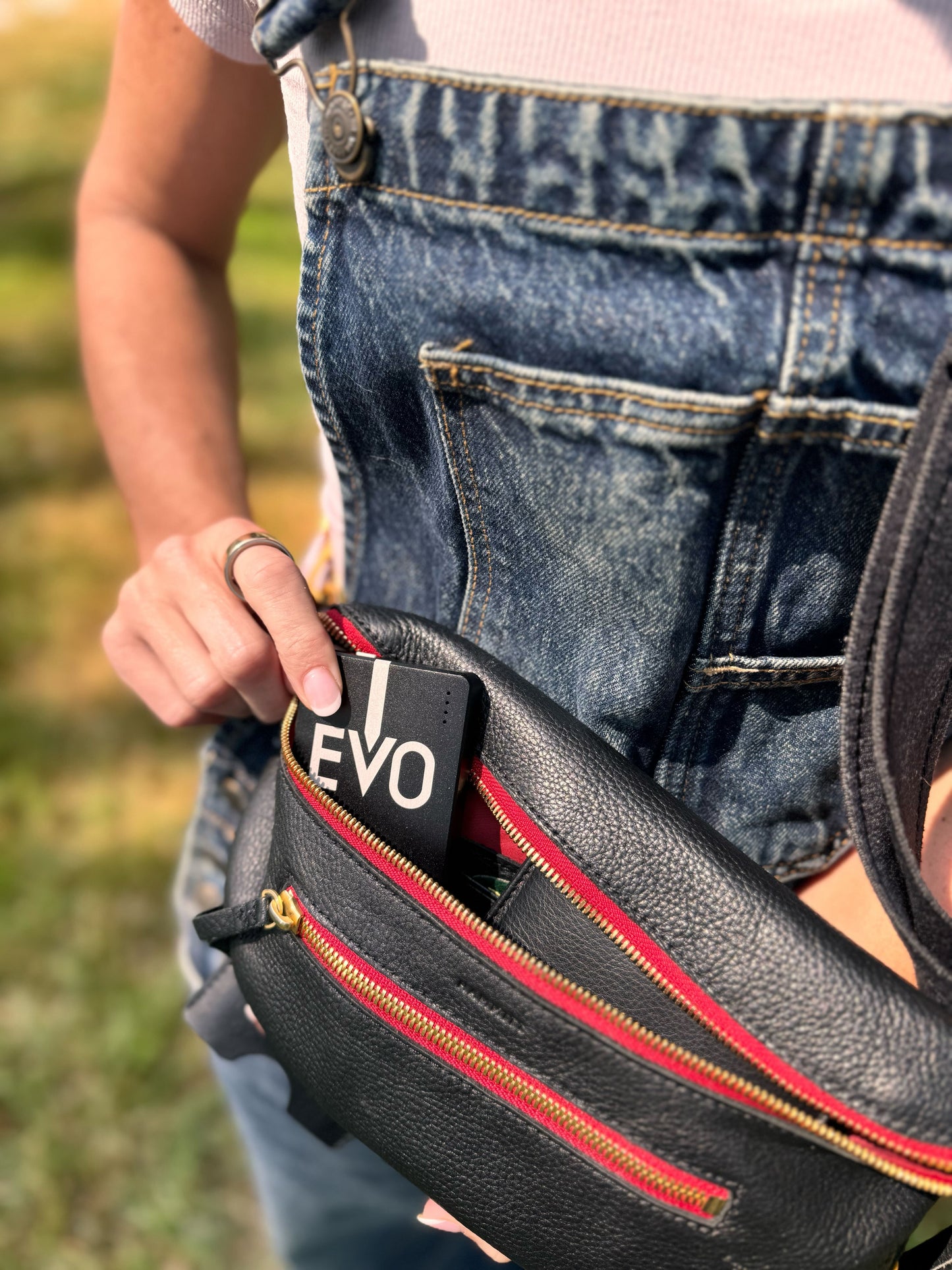 
                  
                    A person puts the EVO portable inside of their purse
                  
                