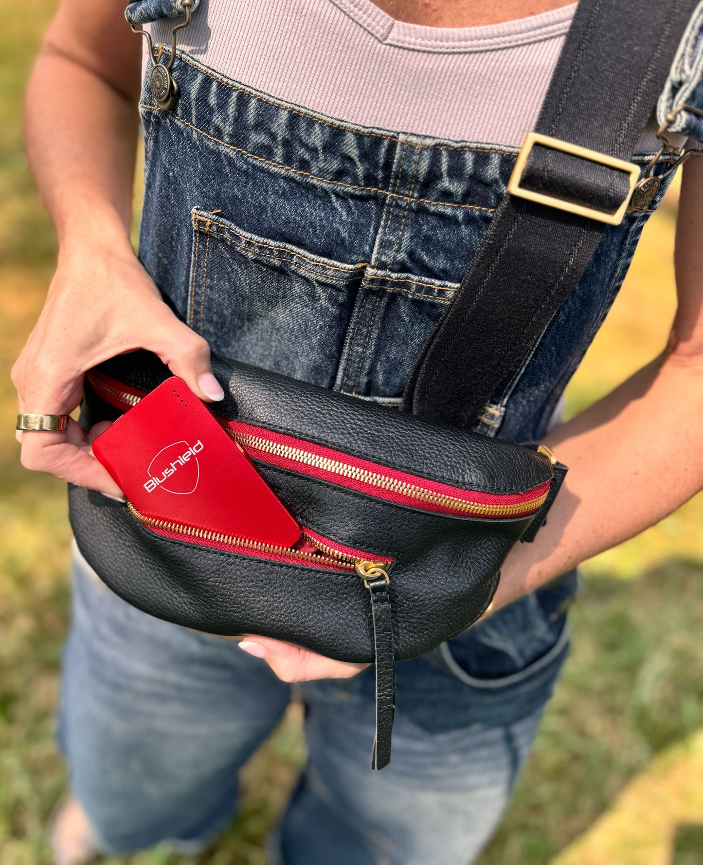
                  
                    A person puts the Sensitive portable inside of their purse
                  
                